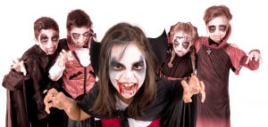 Group of kids with face-paint and Halloween vampire costumes